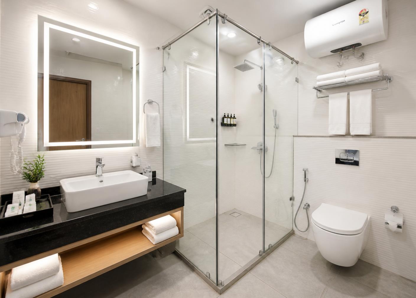 Spotless bathroom with hot water geyser and shower